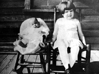 Erma, at less than a year old, sits next to sister Rose Annie Stancil in 1908.